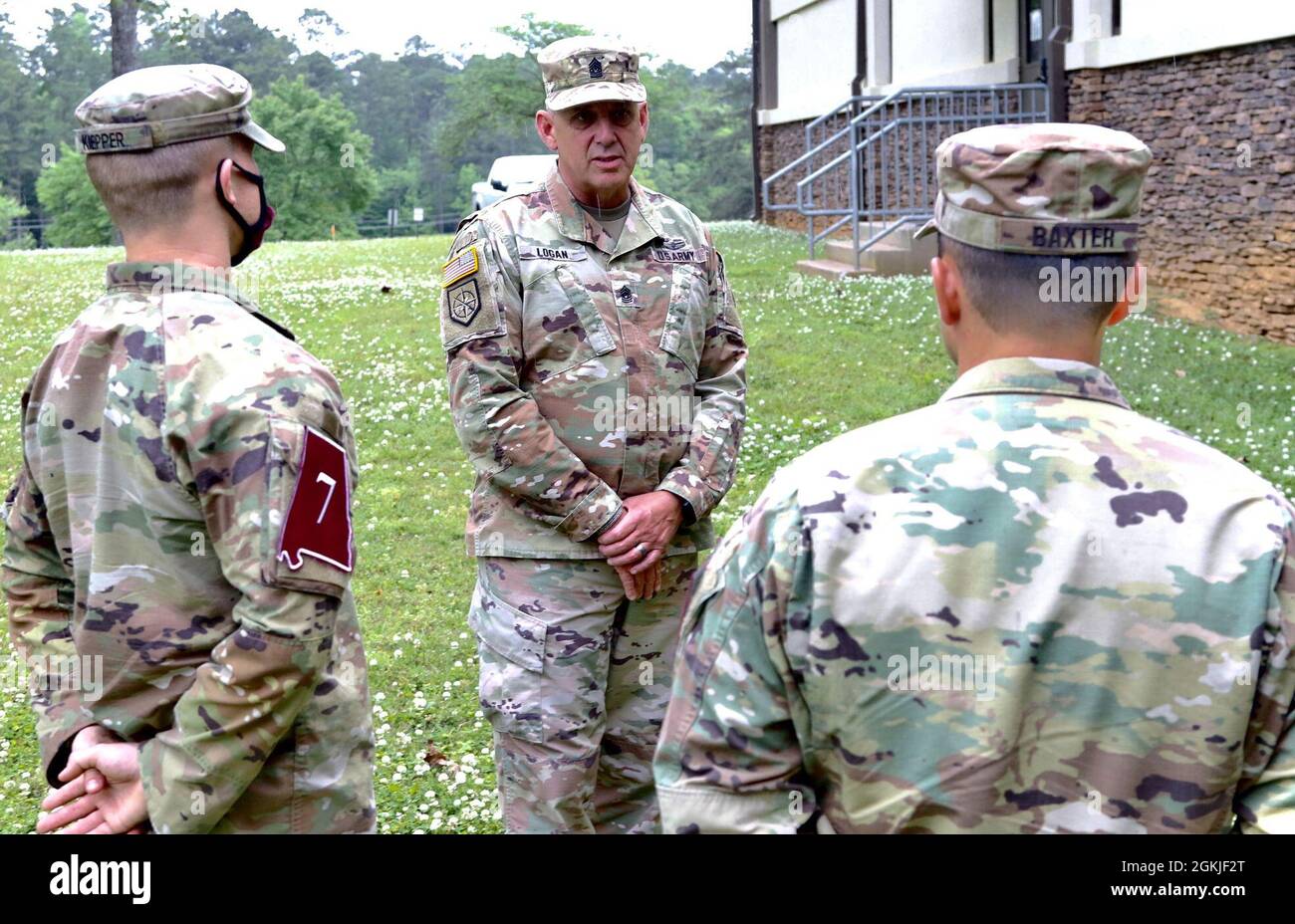 U.S. Army Command Sgt. Maj. Jeff Logan, the state command sergeant major of the Georgia Army National Guard, gives encouraging words to Spc. Brant Kiepper (left) and Sgt. James Baxter (right) May 2, 2021, at Ft. McClellan, Alabama. Baxter and Kiepper, representing the state of Georgia, began their first day at the Region III Best Warrior Competition. Stock Photo