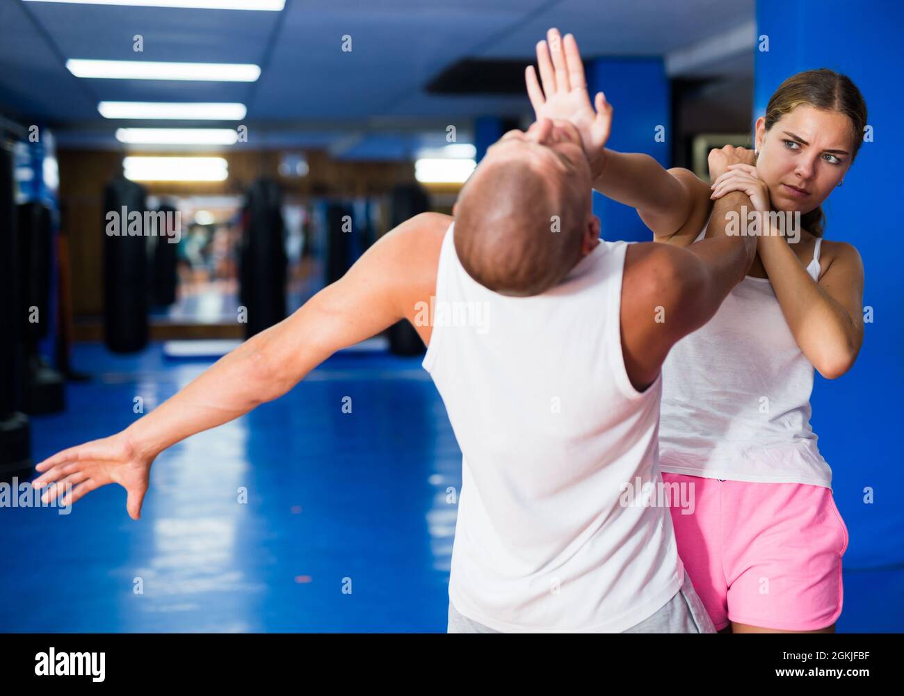 Young woman practicing palm strike with man in self defense training Stock Photo Alamy