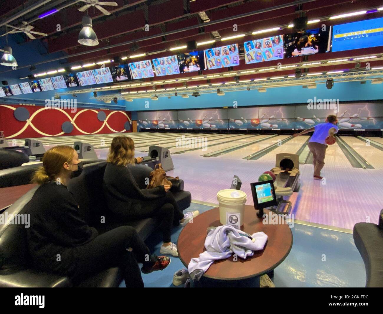 Kelly DeJardin (center) and her children enjoy family time at the bowling alley on Caserma Ederle May 2. The DeJardins are one of the 83 U.S. displaced families forced to leave their home when Italian officials evacuated downtown Vicenza to defuse a World War II bomb. Stock Photo