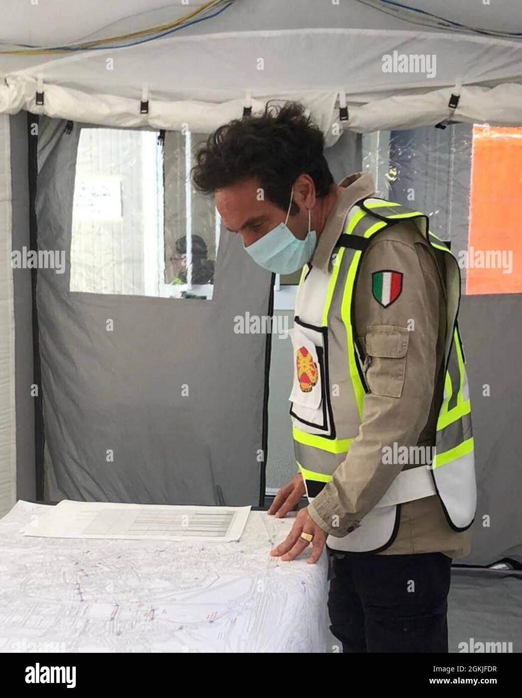 Host nation coordinator Antonio Quaglia reviews an evacuation map while supporting the U.S. Army Garrison operations’ team from the Vicenza’s emergency center May 2.  The garrison provided services to the 150 Americans forced to leave their homes when Italian officials evacuated downtown Vicenza for a daylong operation planned to defuse a World War II bomb. Stock Photo