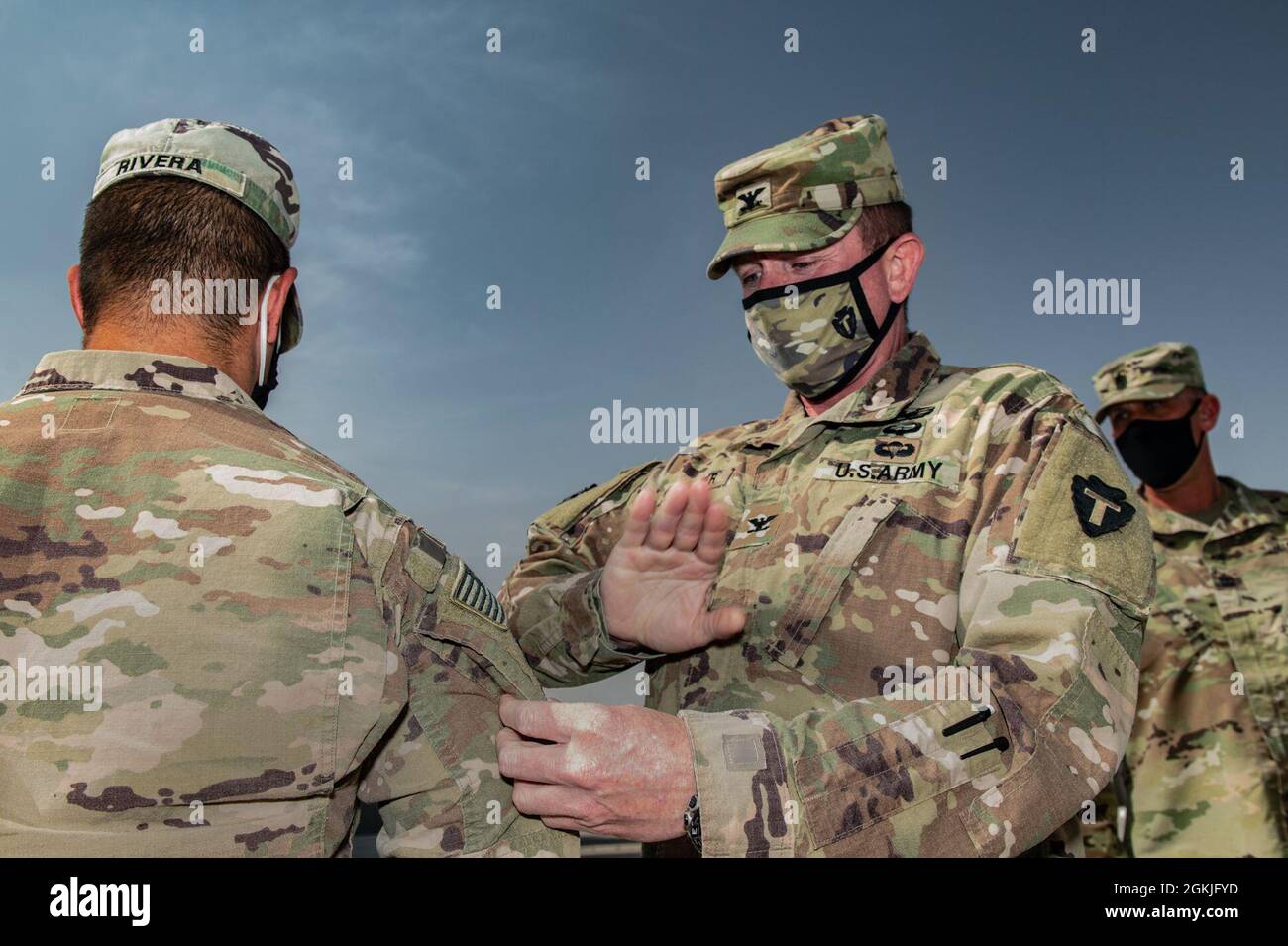 U.S. Army Maj. Rafael Rivera from Task Force Spartan receives his right sleeve insignia during a ceremony hosted by the Division Tactical-Jordan Officer in Charge, Col. Christopher Fletcher, and Sgt. Maj. Daniel Johnson at the Joint Training Center-Jordan, May 3, 2021. Brig. Gen. Win Burkett, Task Force Spartan Assistant Commanding General- Operations spoke a few words commemorating the special day for each of the recipients. Stock Photo