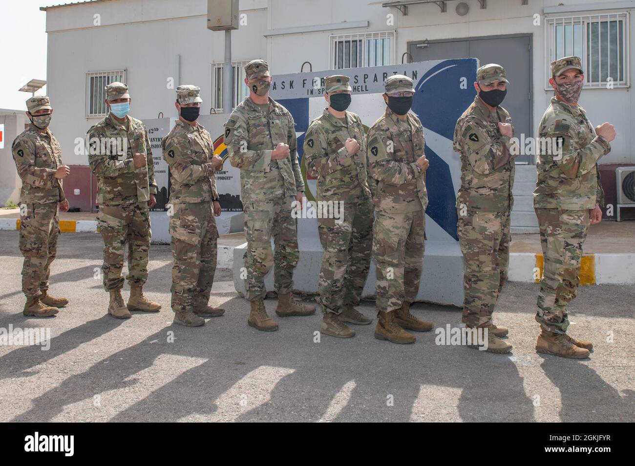 U.S. Army Soldiers from Task Force Spartan flex their right sleeves showing their new T-Patch insignia during a ceremony at the Joint Training Center hosted by the Division Tactical-Jordan Officer in Charge, Col. Christopher Fletcher and Sgt. Maj. Daniel Johnson for Division Tactical, May 3, 2021. Brig. Gen. Win Burkett, Task Force Spartan Assistant Commanding General- Operations spoke a few words commemorating their special day. Stock Photo