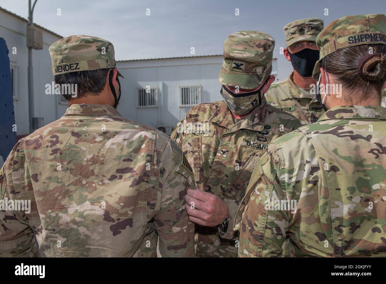 U.S. Army Maj. Chris Mendez from Task Force Spartan receive his right sleeve insignia during a ceremony hosted by the Division Tactical-Jordan Officer in Charge, Col. Christopher Fletcher, and Sgt. Maj. Daniel Johnson for Division Tactical at the Joint Training Center-Jordan, May 3, 2021. Brig. Gen. Win Burkett, Task Force Spartan Assistant Commanding General- Operations spoke a few words commemorating the special day for each of the recipients. Stock Photo