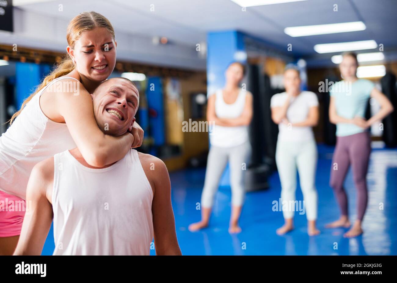 Young woman performing chokehold Stock Photo - Alamy