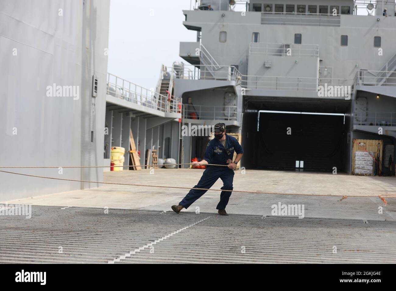 A U.S. Army Maritimer pulls on a rope to help secure a Logistics Support Vessel May 3, 2021, during the opening exercise of DEFENDER-Europe 21 at Durres Port, Albania. DEFENDER-Europe 21 is a large-scale U.S. Army-led exercise designed to build readiness and interoperability between the U.S., NATO allies and partner militaries. This year, more than 28,000 multinational forces from 26 nations will conduct nearly simultaneous operations across more than 30 training areas in more than a dozen countries from the Baltics to the strategically important Balkans and Black Sea Region. Follow the latest Stock Photo