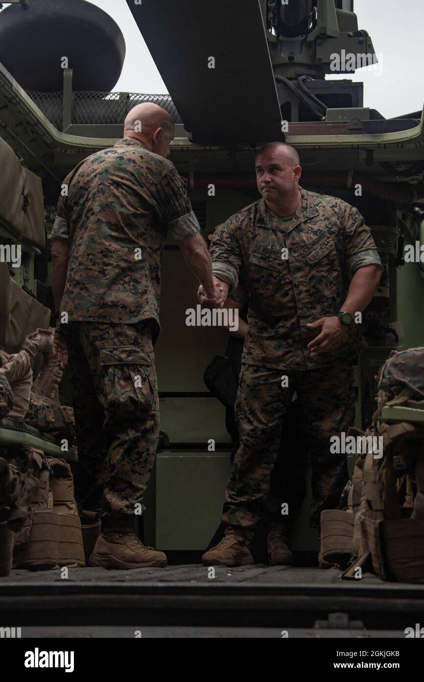 U.S. Marine Corps Gunnery Sgt. Joseph Welday, with 2d Assault Amphibian Battalion, 2d Marine Division, briefs U.S. Marine Gen. David H. Berger, the 38th commandant of the Marine Corps, during a visit to Camp Lejeune, N.C., May 3, 2021. Berger visited Camp Lejeune to ensure the welfare of Marines at 2d Marine Division, and receive updates on equipment, plans, and procedures for Marines training. Stock Photo