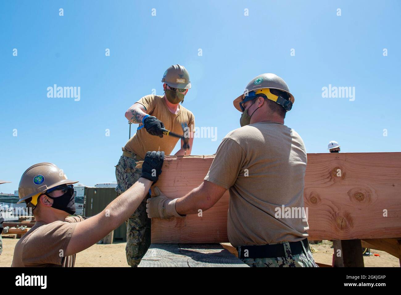 210503-N-TP832-1127 PORT HUENEME, Calif. (May 3, 2021) Builder 3rd Class Joshua Kitchin, assigned to U.S. Naval Mobile Construction Battalion (NMCB) 3, hammers a nail to construct a heavy timber bridge as part of a Command Post Exercise on board Naval Base Ventura County, Port Hueneme. Seabees are the expeditionary engineering and construction experts of the naval service. They provide task-tailored, adaptable and combat-ready engineering and construction forces that deploy to support Navy objectives globally. Stock Photo