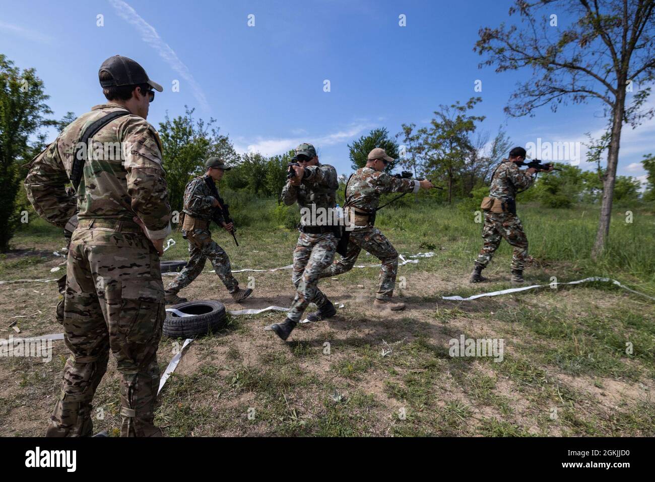 A U.S. Army Green Beret watches as soldiers from North Macedonia’s