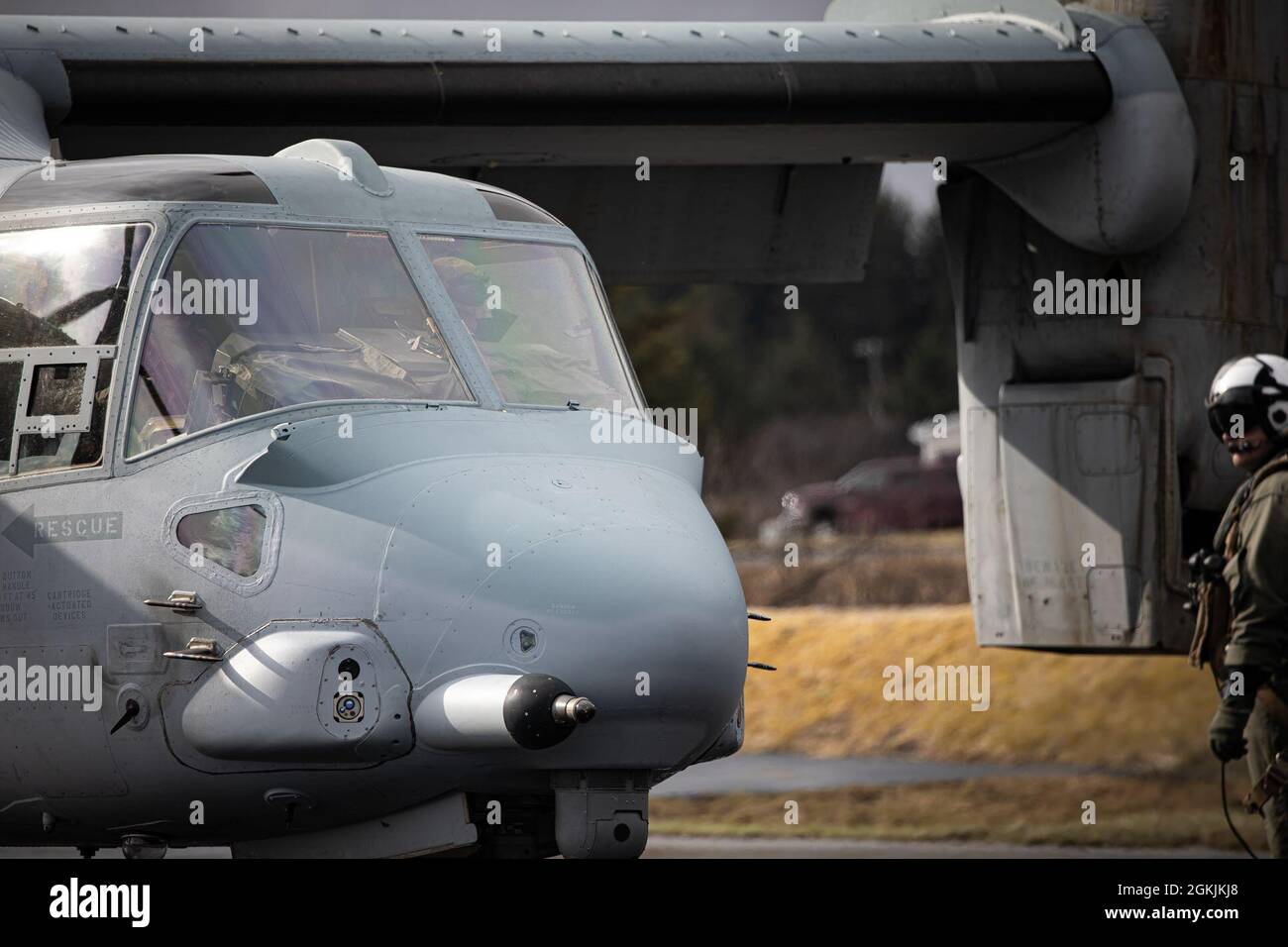 A U.S. Marine with Medium Tiltrotor Squadron 764, 4th Marine Aircraft Wing, observes an MV-22 Osprey before takeoff during Arctic Care 2021 in Kodiak, Alaska, on May 5, 2021. Arctic Care 2021 is a joint-service training mission led by the United States Air Force and supported by members of the Air National Guard, Marines, Marine Reserves, Navy, Navy Reserves, National Guard, and Army Reserves. Stock Photo