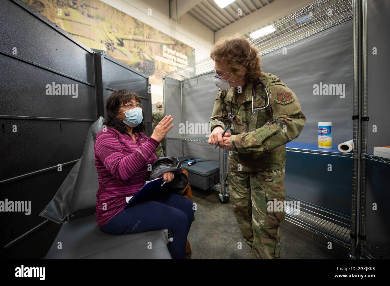 U.S. Air National Guard Maj. Debra Triplehorn, 168th Medical Group, 168th Wing, meets with a Kodiak Island resident during Arctic Care 2021 in Kodiak, Alaska, on May 5, 2021. Arctic Care 2021 provides medical troops and support personnel “hands-on” readiness training while providing no-cost medical care to the people of Kodiak, Alaska. Stock Photo