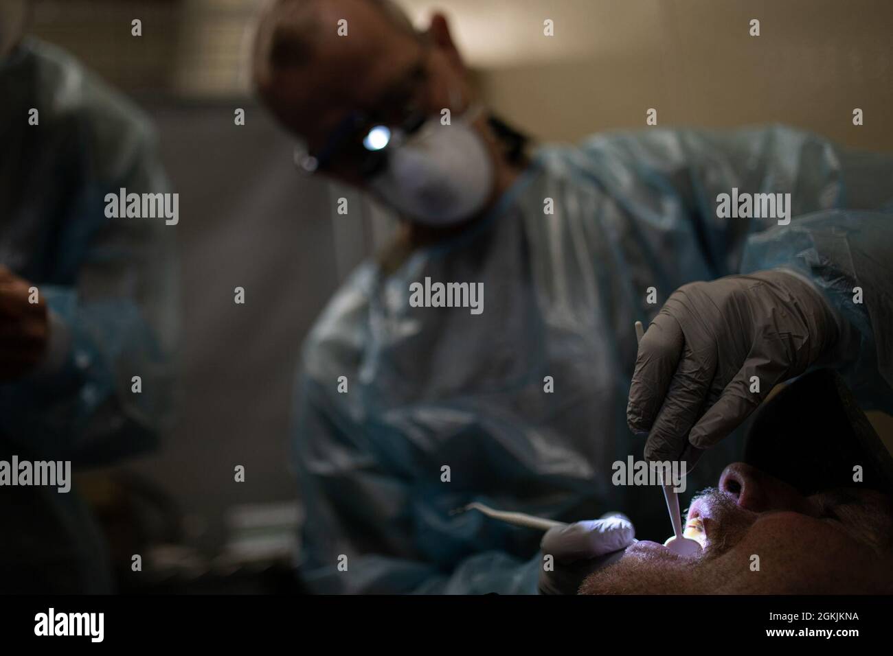 U.S. Air National Guard Major Raymond Martin, 102nd Medical Group, 102nd Intelligence Wing, conducts a dental exam for a Kodiak Island resident during Arctic Care 2021 in Kodiak, Alaska, on May 5, 2021. Arctic Care 2021 provides medical troops and support personnel “hands-on” readiness training while providing no-cost medical care to the people of Kodiak, Alaska. Stock Photo