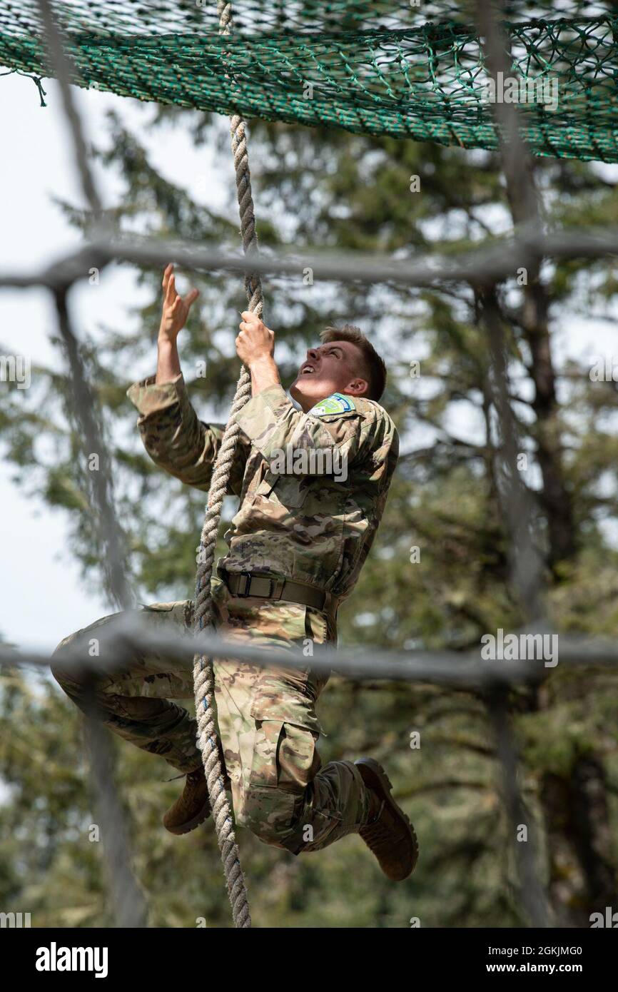 North Dakota Army National Guard Sgt. Brandon Wendland climbs a rope to ...