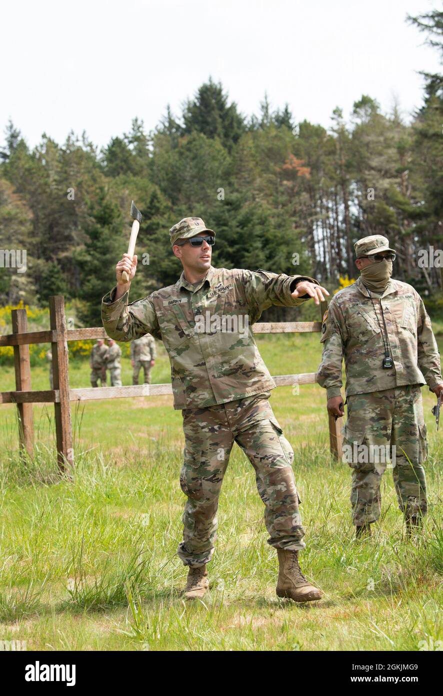 Wyoming Army National Guard Staff Sgt. Joshua Barry throws a hatchet at a target during the 2021 Region Six Best Warrior Competition at Camp Rilea, near Warrenton, Ore., on May 5, 2021. Soldiers are competing in nearly 20 events that were part of the 2021 Region VI Best Warrior Competition hosted by the Oregon National Guard. The competition included Soldiers from Alaska, Idaho, Montana, North Dakota, Oregon, South Dakota, Washington and Wyoming. Stock Photo