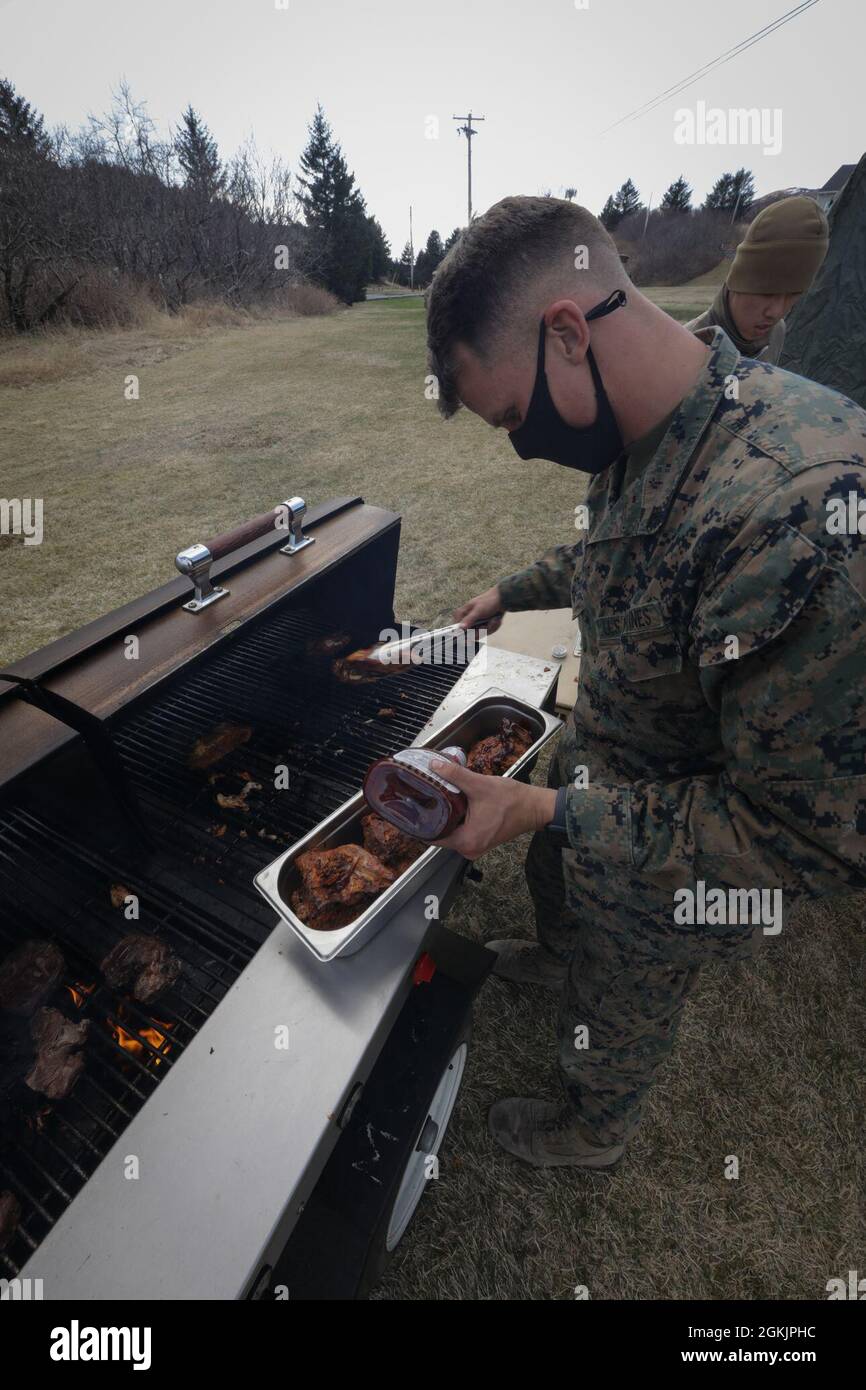 U.S. Marine Corps Cpl. Charles Squires III, a food service specialist with Combat Logistics Regiment 45, 4th Marine Logistics Group, prepares dinner for Marines during Arctic Care 2021 in Kodiak, Alaska, on May 6, 2021. Arctic Care 2021 is a joint-service training mission led by the United States Air Force and supported by members of the Air National Guard, Marines, Marine Reserves, Navy, Navy Reserves, National Guard, and Army Reserves. Stock Photo