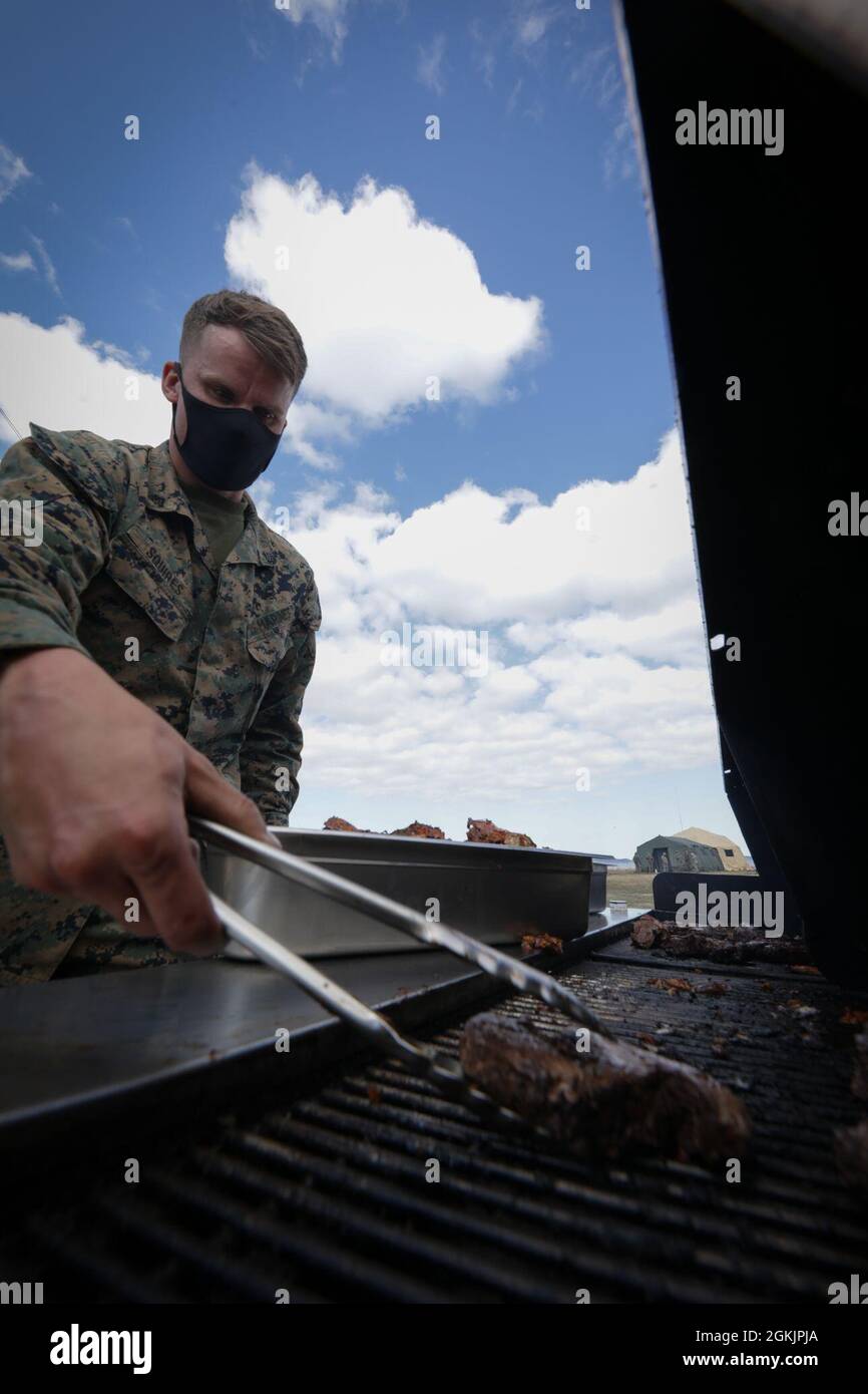 U.S. Marine Corps Cpl. Charles Squires III, a food service specialist with Combat Logistics Regiment 45, 4th Marine Logistics Group, prepares dinner for Marines during Arctic Care 2021 in Kodiak, Alaska, on May 6, 2021. Arctic Care 2021 is a joint-service training mission led by the United States Air Force and supported by members of the Air National Guard, Marines, Marine Reserves, Navy, Navy Reserves, National Guard, and Army Reserves. Stock Photo