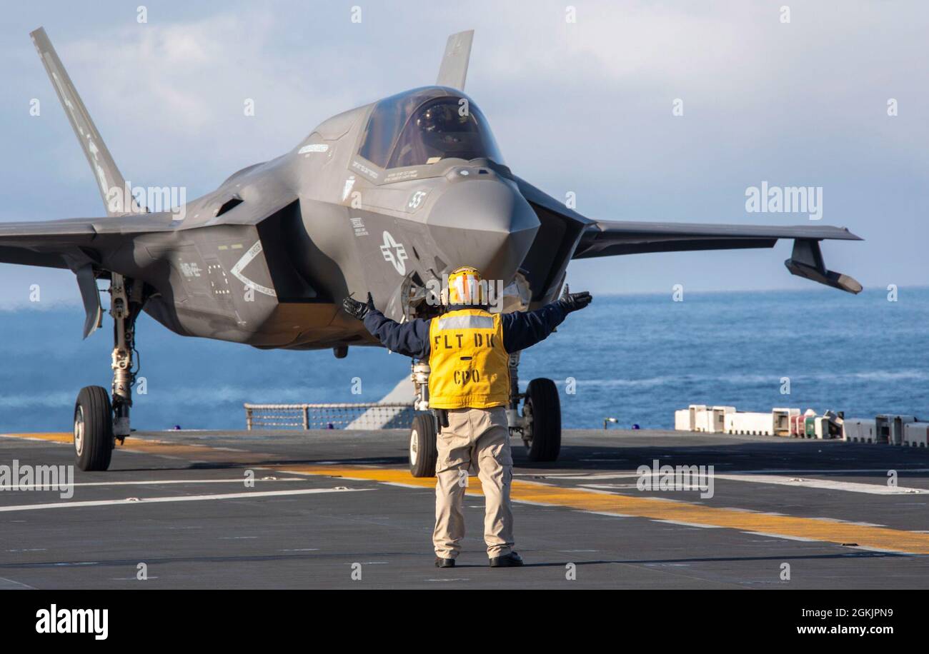 210506-N-LD903-2032  GULF OF ALASKA (May 6, 2021) – U.S. Navy Chief Aviation Boatswain’s Mate (Handling) Andres Bonilla directs an F-35B Lightning II, assigned to Marine Medium Tiltrotor Squadron 164 (Reinforced), 15th Marine Expeditionary Unit, aboard the amphibious assault ship USS Makin Island (LHD 8) in support of Northern Edge 2021. Approximately 15,000 U.S. service members are participating in a joint training exercise hosted by U.S. Pacific Air Forces May 3-14, 2021, on and above the Joint Pacific Alaska Range Complex, the Gulf of Alaska, and temporary maritime activities area. NE21 is Stock Photo