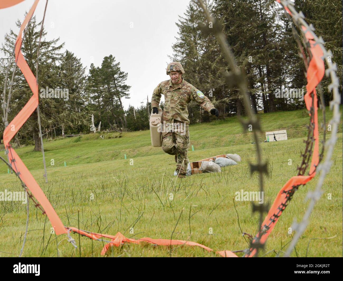Oregon Army National Guard Sgt. John Mayer carries a heavy canister ...