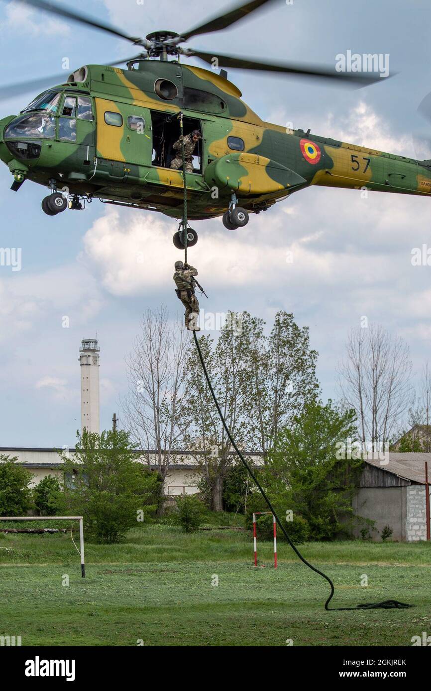 Special warfare operators from Georgia, Romania, Spain and the United  States fast rope from a Romanian IAR 330 Puma helicopter as a part of  Trojan Footprint 21 in Mangalia, Romania on May
