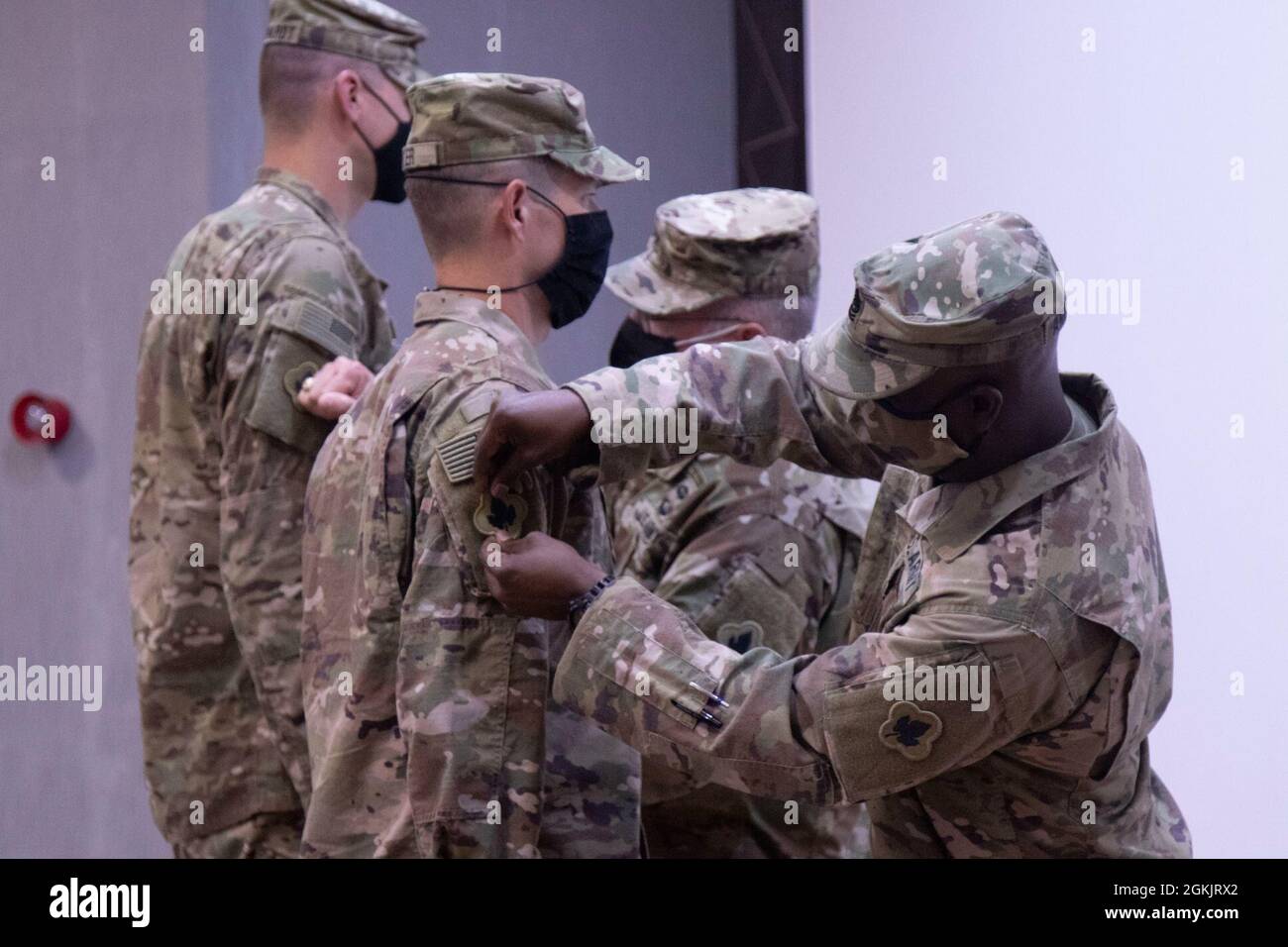 Command Sergeant Major Orlando Anderson, Command Sergeant Major Area Support Group Jordan, patches Master Sergeant Lucas Geyer , 192nd Military Police Detachment, during the patching ceremony on Joint Training Center in Jordan. The 192nd MP Detachment fall under the ASG-J command and will now wear the 43 Infantry Division patch on their right sleeve. Stock Photo