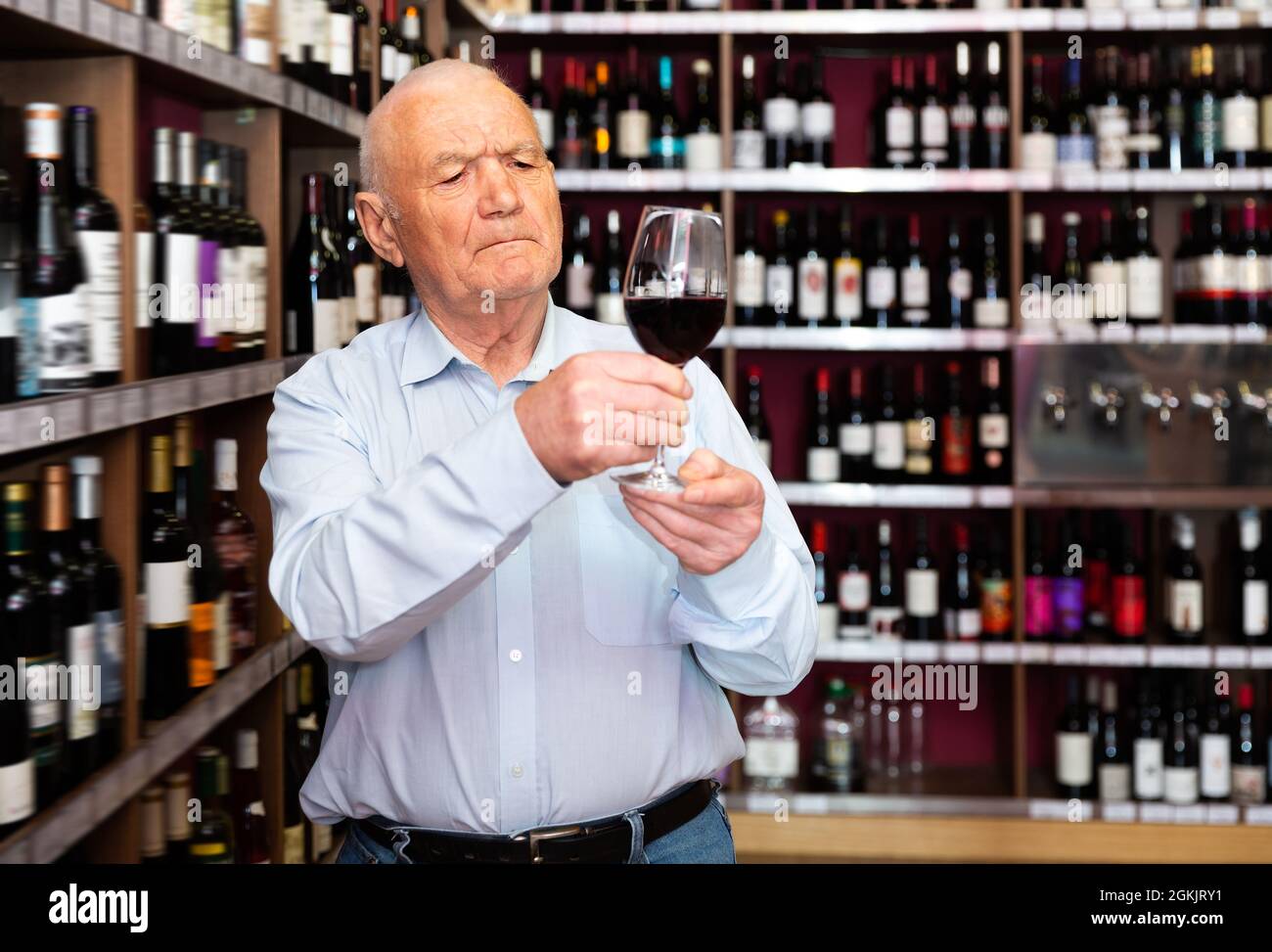 Portrait of senior man tasting red wine Stock Photo - Alamy