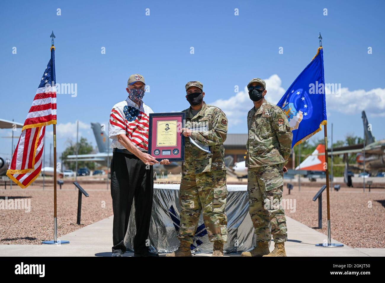 Staff Sgt. Christopher S. Sparks, center, Airman Leadership School graduate, accepts the John L. Levitow award during the graduation of ALS class 21-5, May, 6, 2021, on Holloman Air Force Base, New Mexico. The John L. Levitow award is presented to the student demonstrating the highest level of leadership and scholastic performance, and is determined by the assignment of points by their peers. Stock Photo