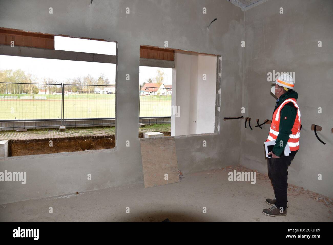 U.S. Army Corps of Engineers, Europe District Project Engineer Johann Buchfelder checks out ongoing construction of a new field house at Vilseck High School at Rose Barracks in U.S. Army Garrison Bavaria May 6, 2021. The new field house, adjacent to the school’s athletics field, will not only serve as an area to store athletics equipment but is being designed as a focal point for social activities and events. The project is part of the Army’s push for new and improved housing and other facilities to improve quality of life for Soldiers and their families stationed at Rose Barracks. Stock Photo