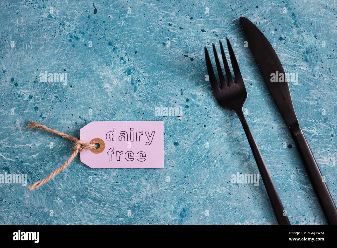dairy-free product tag with fork and knife, concept of healthy nutrition  and ethical choices Stock Photo - Alamy