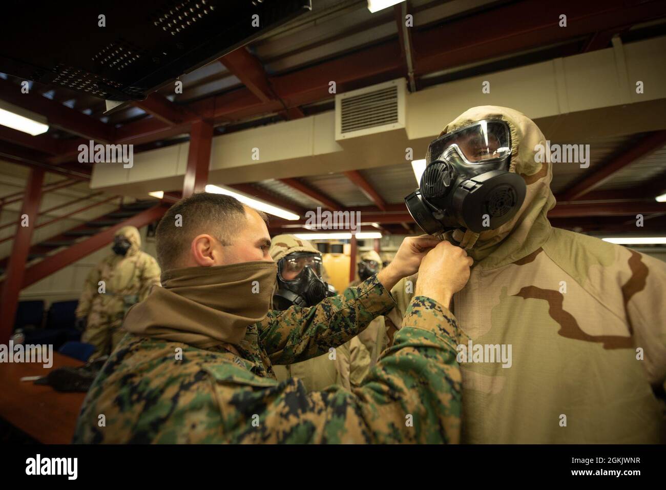 U.S. Marines don Mission Oriented Protective Posture (MOPP) gear for Chemical, Biological, Radiological, and Nuclear (CBRN) defense training during Arctic Care 2021 in Kodiak, Alaska, on May 7, 2021. Arctic Care 2021 is a joint-service training mission led by the United States Air Force and supported by members of the Air National Guard, Marines, Marine Reserves, Navy, Navy Reserves, National Guard, and Army Reserves. Stock Photo