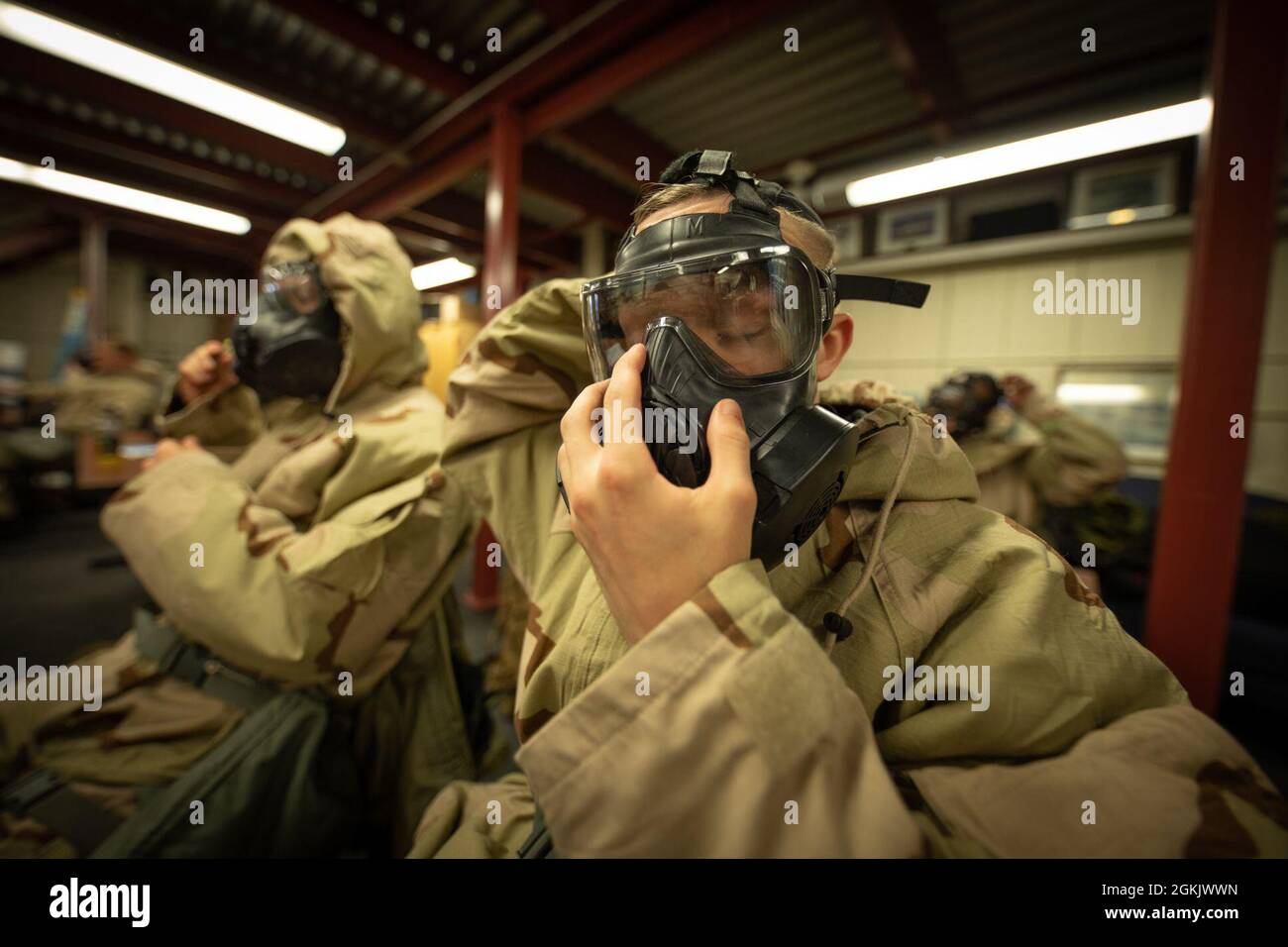 U.S. Marines don Mission Oriented Protective Posture (MOPP) gear for Chemical, Biological