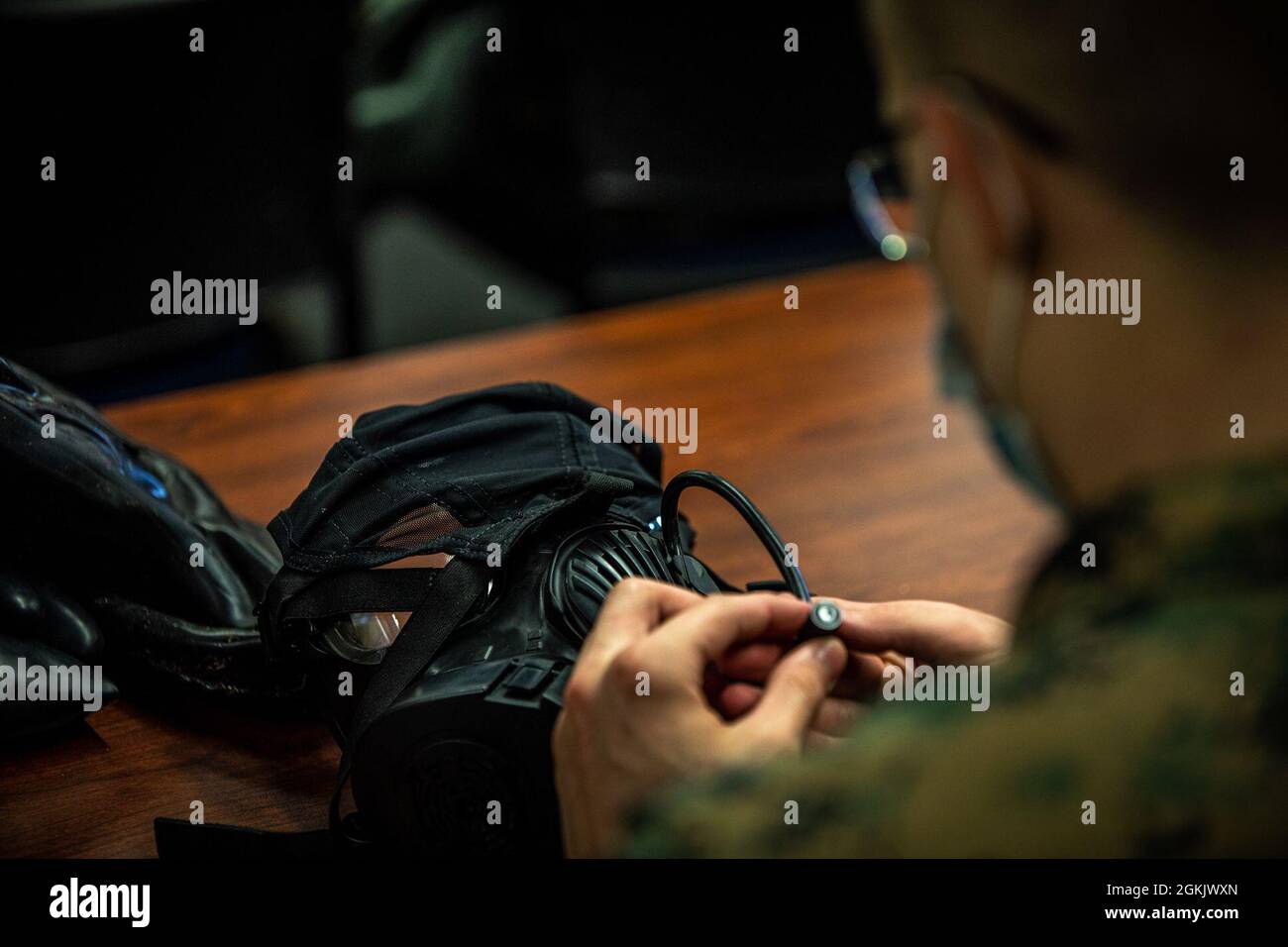 U.S. Marines conduct service checks of their M50 joint service general purpose masks for Chemical, Biological, Radiological, and Nuclear (CBRN) defense training during Arctic Care 2021 in Kodiak, Alaska on May 7, 2021. Arctic Care 2021 is a joint-service training mission led by the United States Air Force and supported by members of the Air National Guard, Marines, Marine Reserves, Navy, Navy Reserves, National Guard, and Army Reserves. Stock Photo