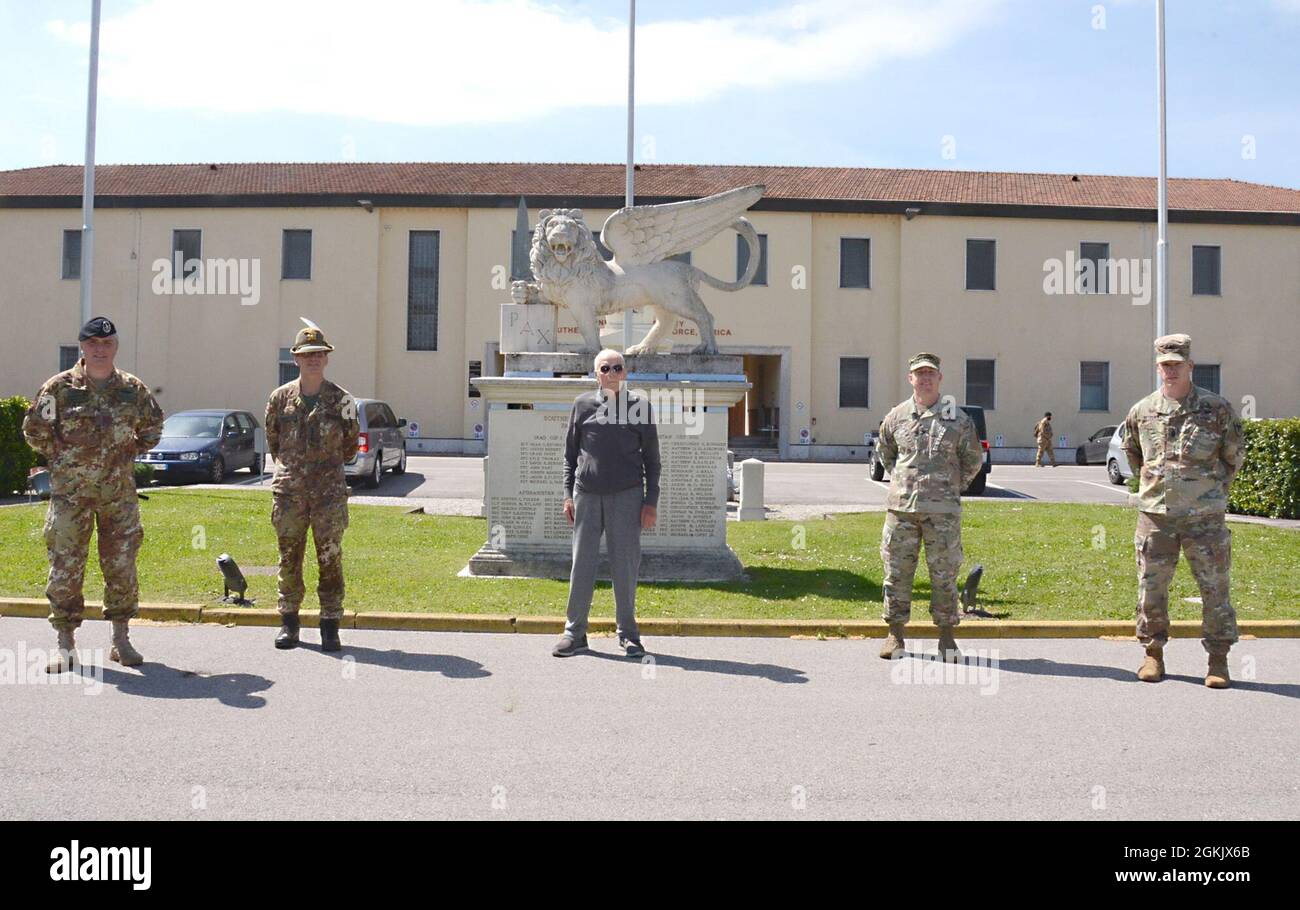 VICENZA, Italy (May 7, 2021) - From left to right: Italian Base Command Sgt. Maj. Ennio Zavagno, command sergeant major; Col. Michele Biasiutti, IBC commander; Pietro Luigi Colombo; U.S. Army Garrison Italy Col. Daniel Vogel, commander and Command Sgt. Major Scott Vetten, command sergeant major, pose for a picture May 7, 2021, after welcoming back Colombo who worked on Caserma Ederle in the early 1950’s.  Colombo’s visit, which was a special surprise for his 91st birthday, brought back fond memories of his military service and his time in Vicenza. Stock Photo