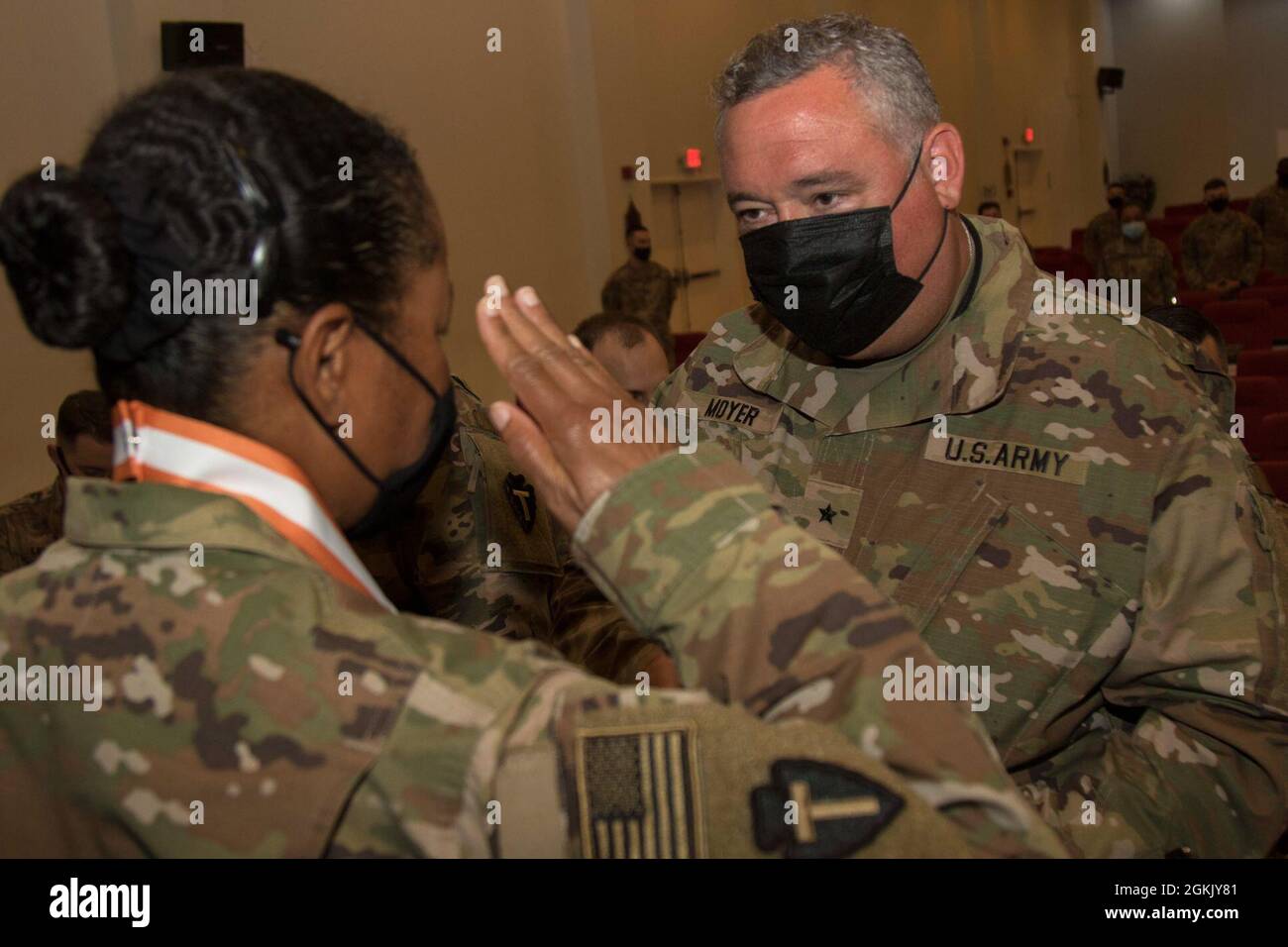 U.S. Army Sgt. 1st Class Nicole Perkins, a Signal Soldier from 36th  Infantry Division, Task Force Spartan, salutes Brig. Gen. Jonathan C.  Moyer, 335th Signal Theater Provisional commander, after he places The