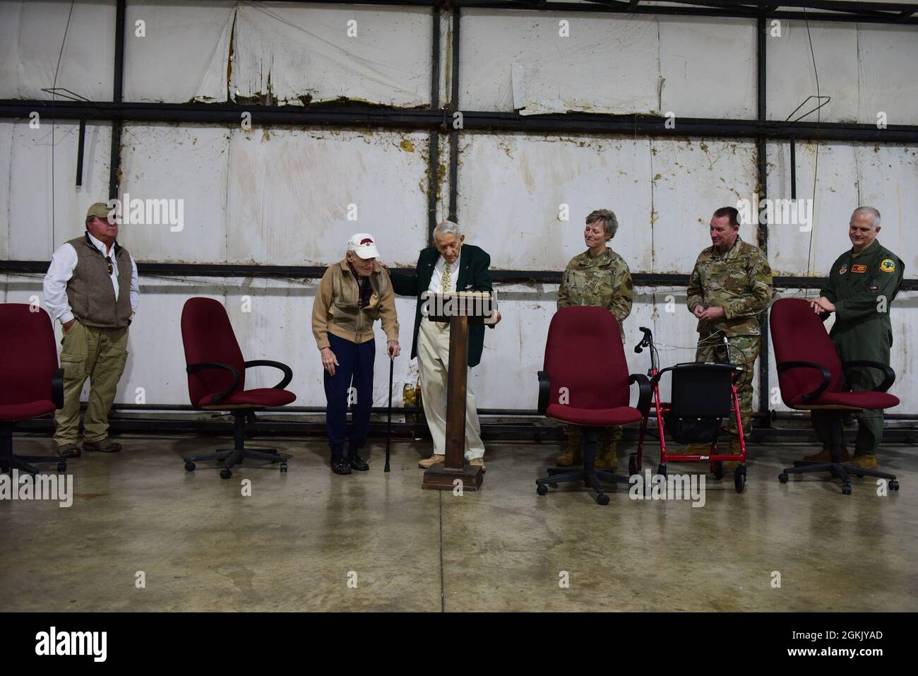 U.S. Air Force Lt. Col. (retired) Darrell Larkin stands to be coined by
