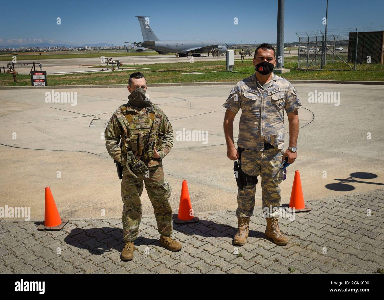 Security forces members with the 39th Security Forces Squadron, left, and Turkish Air Force stand along the perimeter of a hot refueling exercise at Incirlik Air Base, Turkey, May 10, 2021. The training event was an opportunity for U.S. and Turkish Airmen to increase interoperability and proficiency in rapid deployment for future Agile Combat Employment operations. Stock Photo