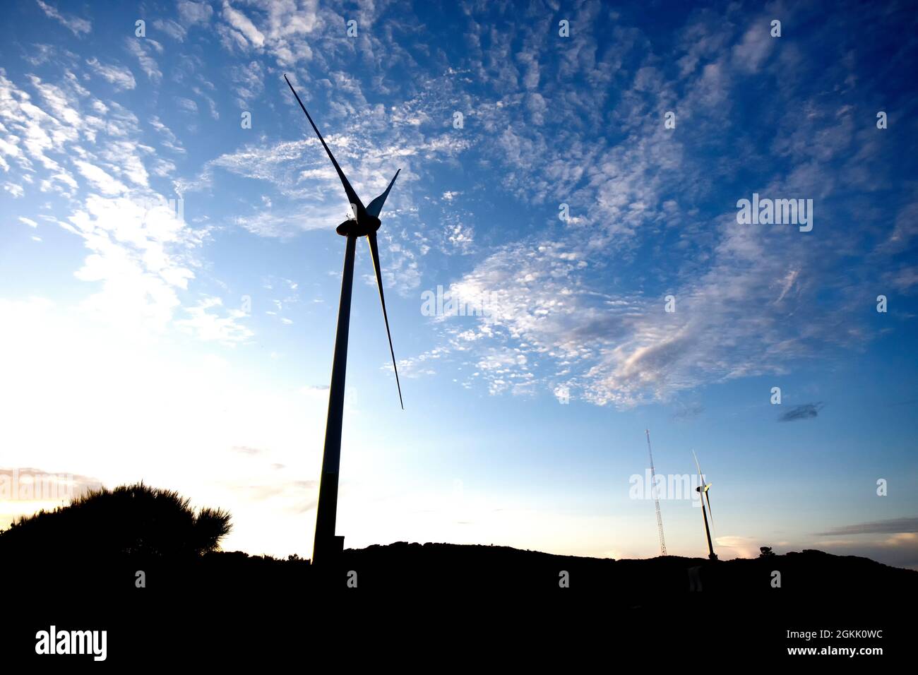 wind turbines silhouette on mountain at the sunset Stock Photo - Alamy