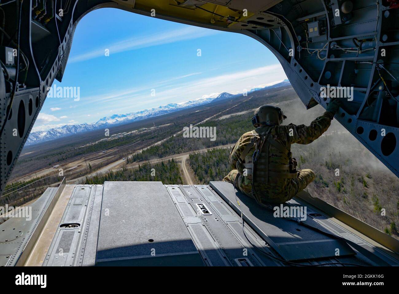 U.S. Army Staff Sgt. Manuel Rodriguez, a CH-47F Chinook helicopter flight engineer from B Company, 1st Battalion, 52nd Aviation Regiment, observes the environment during Northern Edge 2021 (NE21) over the Joint Pacific Alaska Range Complex (JPARC) May 10, 2021. The JPARC consists of approximately 65,000 square miles of available airspace, 2,490 square miles of land space with 1.5 million acres of maneuver land and 42,000 square nautical miles of surface, subsurface and overlaying airspace. Northern Edge 2021 is a U.S. Indo-Pacific Command sponsored, Headquarters Pacific Air Forces led, U.S.-on Stock Photo