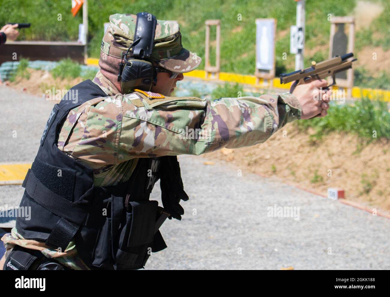 Capt. Nate Hoeger, provost marshal for Regional Command-East, Kosovo Force,  fires a Sig Sauer M17 pistol during an MP range day at Camp Bondsteel,  Kosovo, on May 10, 2021. The MP pistol