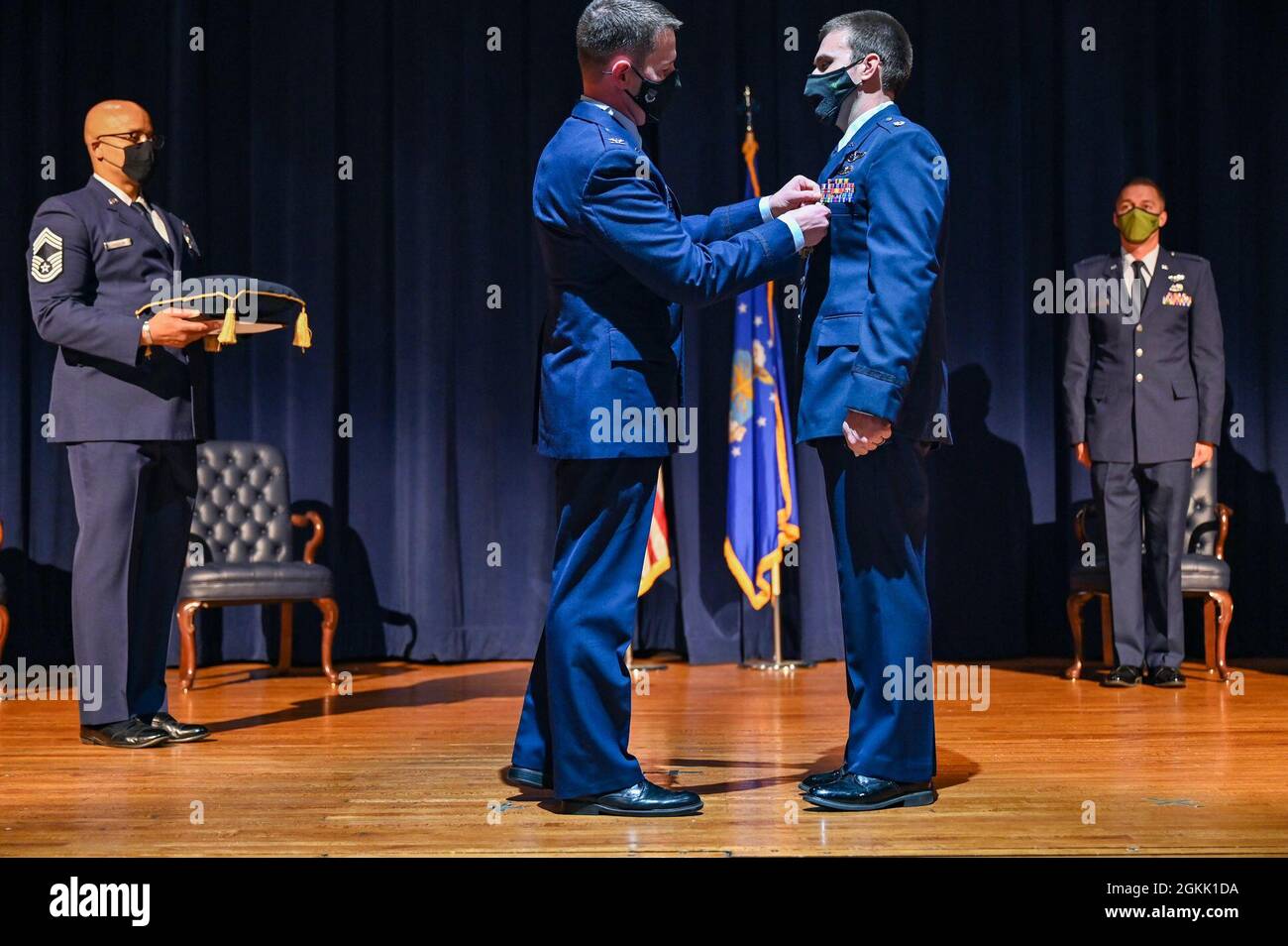 U.S. Air Force Col. John Schutte, 19th Airlift Wing commander, presents ...