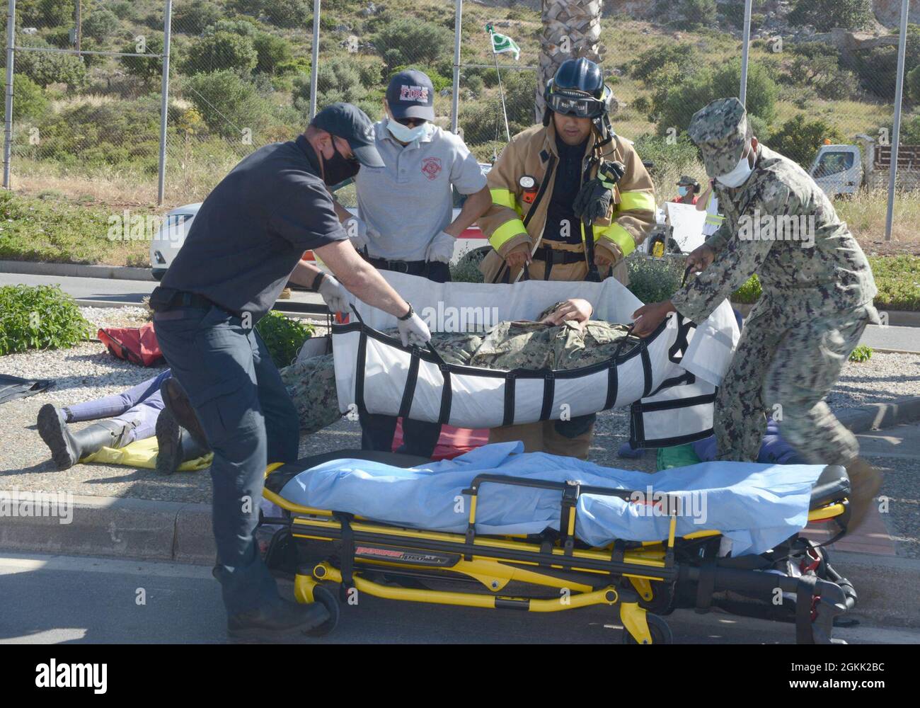 210511-N-AZ866-0250 NAVAL SUPPORT ACTIVITY SOUDA BAY, Greece (May 11, 2021) First responders move a role-playing victim onto a stretcher during an earthquake drill at Naval Support Activity Souda Bay, Greece, May 11, 2021. NSA Souda Bay is an operational ashore base that enables U.S., allied, and partner nation forces to be where they are needed and when they are needed to ensure security and stability in Europe, Africa, and Southwest Asia. Stock Photo