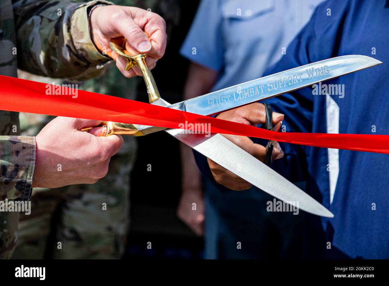 Leadership from the 501st Combat Support Wing prepare to cut a ribbon at RAF Molesworth, England, May 11, 2021. Leadership from RAF Alconbury and RAF Molesworth attended the ceremony to celebrate the reopening of the base gym after months of refurbishing and renovations. Stock Photo