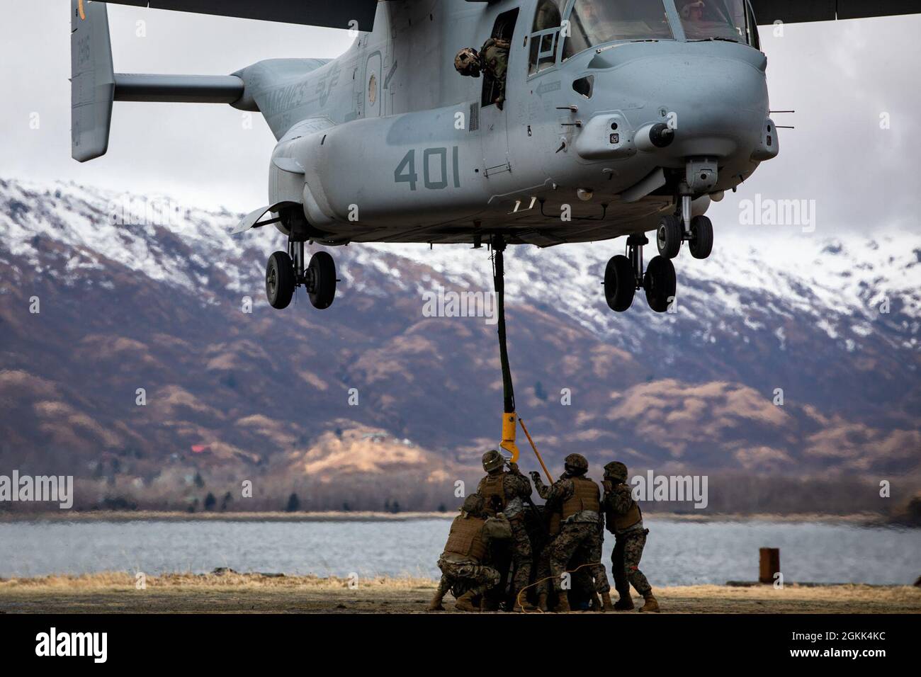 U.S. Marines with VMM-764, 4th Marine Aircraft Wing, conduct external sling loads with a MV-22 Osprey in Kodiak, Alaska on May 12, 2021. Marines with Marine Forces Reserve are currently providing all logistical support to Arctic Care 2021, which is a joint service training mission that provides no-cost medical care to the people of Kodiak, Alaska. Stock Photo