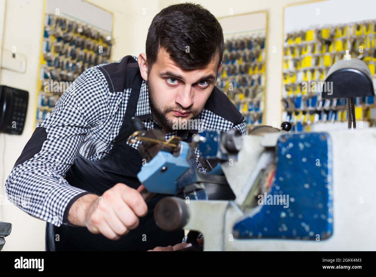 Ordinary male worker making key Stock Photo