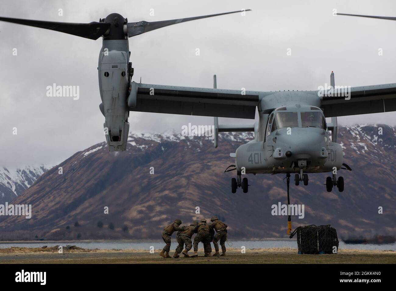 U.S. Marines with VMM-764, 4th Marine Aircraft Wing, conduct external sling loads with a MV-22 Osprey in Kodiak, Alaska on  May 12, 2021. Marines with Marine Forces Reserve are providing logistical support for Arctic Care 2021, which is a joint service training mission that provides no-cost care to residents of Kodiak, Alaska. Stock Photo