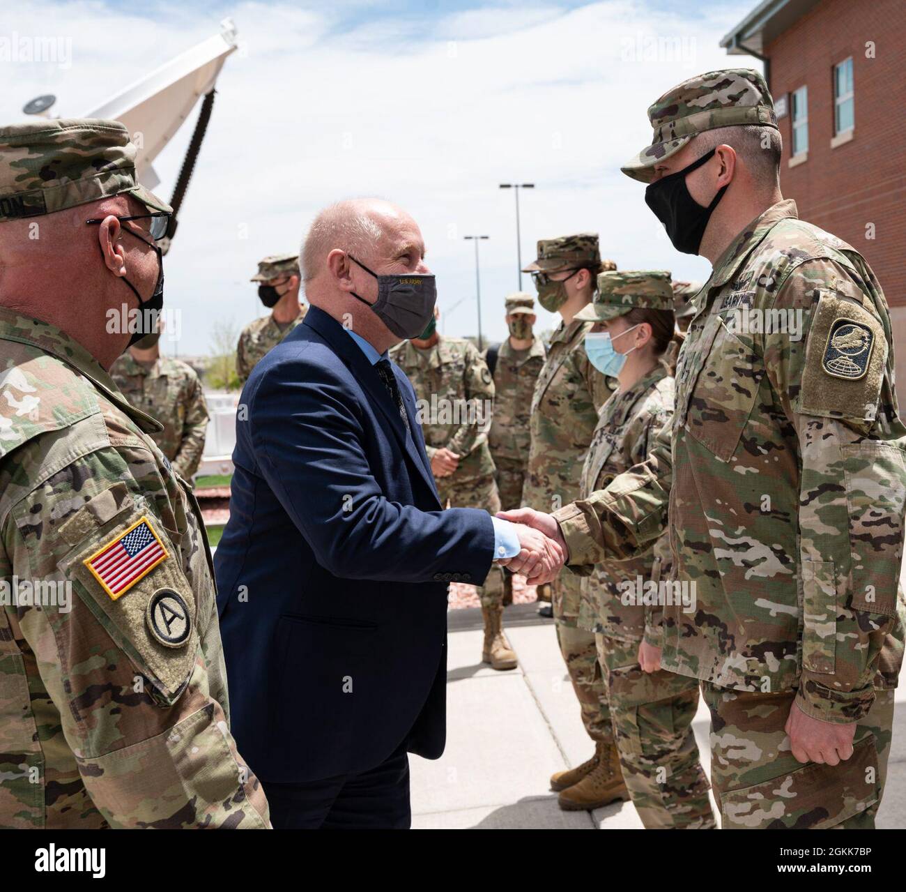 Acting Secretary of the Army, Hon. John E. Whitley presents Master Sgt. Derrick Holmes a challenge coin for his hard work and leadership at 100th Missile Defense Brigade at Fort Carson, Colo., May 13, 2021. Stock Photo