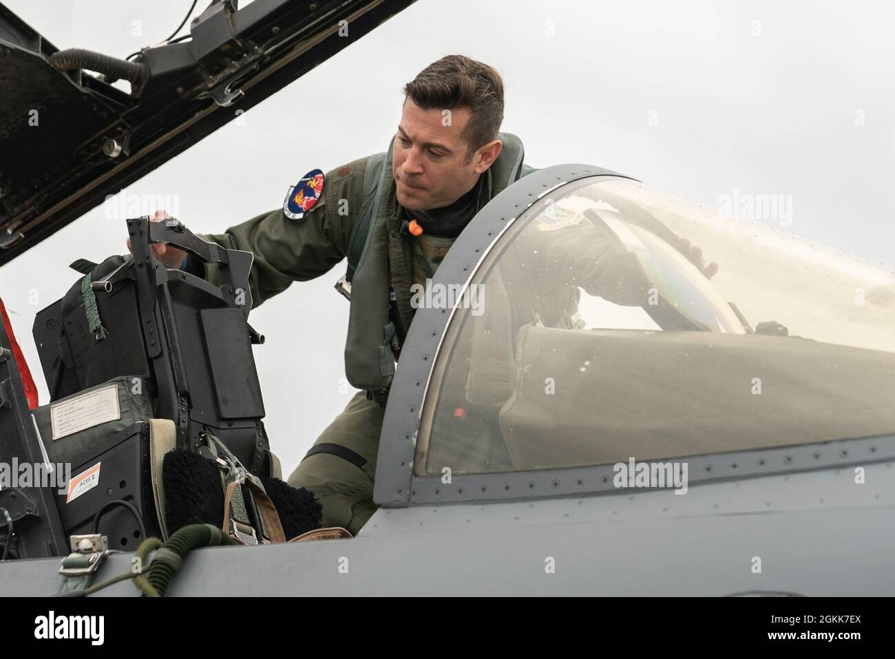 A U.S. Air Force pilot assigned to the 492nd Fighter Squadron climbs into the cockpit of an F-15E Strike Eagle during surge operations at Royal Air Force Lakenheath, England, May 13, 2021. Surge operations are designed to simulate a fast-paced, deployed combat environment to ensure aircrew and support personnel are always ready to execute missions in defense of the United States and its allies. Stock Photo