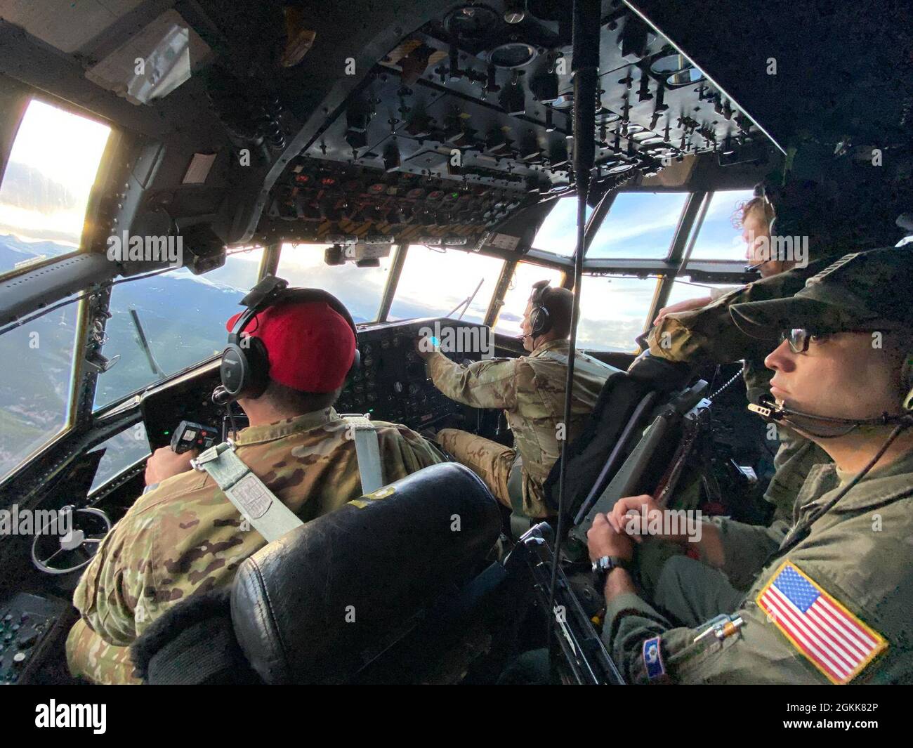 Maj. Tyler Brewer, (red hat) trains for his aircraft commander upgrade with Lt. Col. Jeremy Burton, MAFFS instructor pilot, (middle), Maj. Kevin Greenwood, MAFFS instructor navigator, (right rear), and TSgt. Ben Gonzales, flight engineer, (right front). The crew worked to attain certifications and upgrades as part of the annual aerial Wildland Firefighting (WFF) training and certification with the U.S. Department of Agriculture's Forest Service, using the USDA Forest Service-provided Modular Aerial Fire Fighting System (MAFFS) fixed aboard C-130 Hercules aircraft. Along with Colorado Springs' Stock Photo