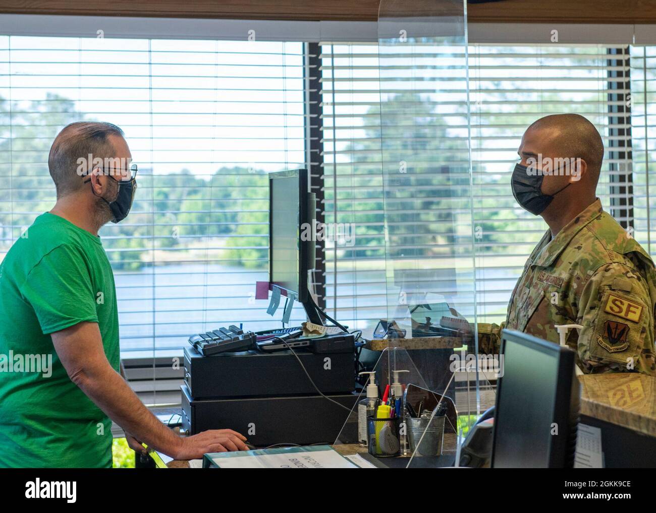 Senior Master Sgt. Jordan Locklear, right, 4th Security Forces Squadron security forces manager, checks out rental equipment with Michael Davis, Outdoor Recreation cashier on Seymour Johnson Air Force Base, North Carolina, May 13, 2021. Outdoor Recreation rents out paddle boards, kayaks, tents, bounce houses, a camper and a large variety of other outdoor activities and equipment. Stock Photo