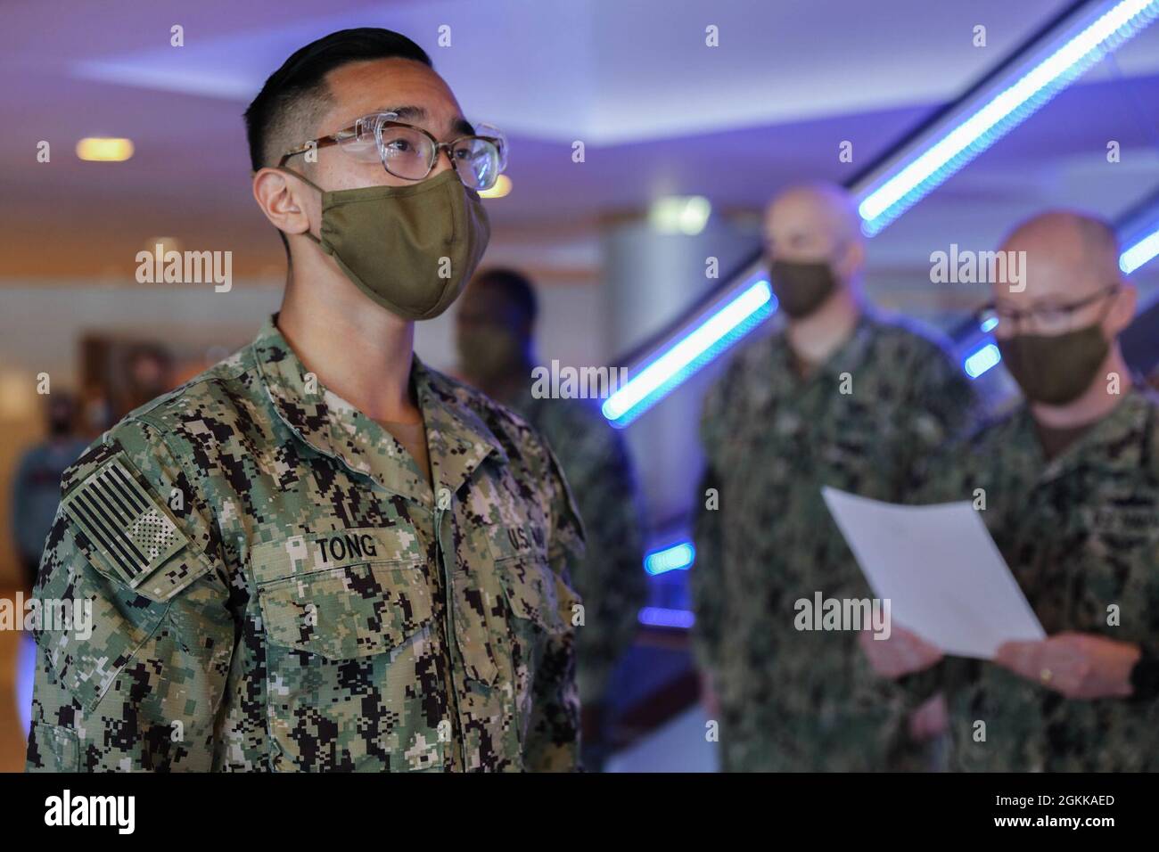U.S. Navy Petty Officer 3rd Class Lane Tong, a hospital corpsman assigned  to Naval Medical Center Portsmouth, Virginia, stands at attention during  his promotion ceremony while deployed in Boston, May 14, 2021.