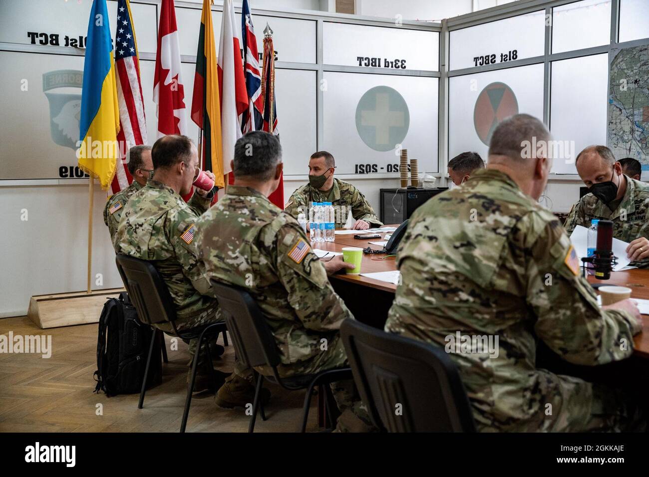 Lt. Gen. John S. Kolasheski, V Corps Commanding General, receives a brief on joint multinational group operations by the command team of Task Force Raven, 81st Stryker Brigade Combat Team, Washington Army National Guard, May 14, 2021, at the International Peacekeeping and Security Center near Yavoriv, Ukraine. Task Force Raven is the command element of the Joint Multinational Training Group-Ukraine, which is responsible for training, advising and mentoring the Ukrainian cadre at the Combat Training Center-Yavoriv to improve Armed Forces Ukraine’s training capacity and defense capabilities.  So Stock Photo