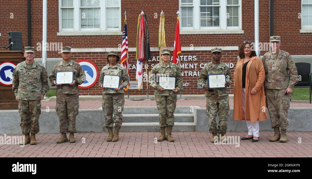 Soldiers of the 1st Theater Sustainment Command, display their certificates after receiving the